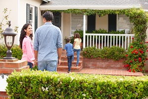 people standing outside of a home